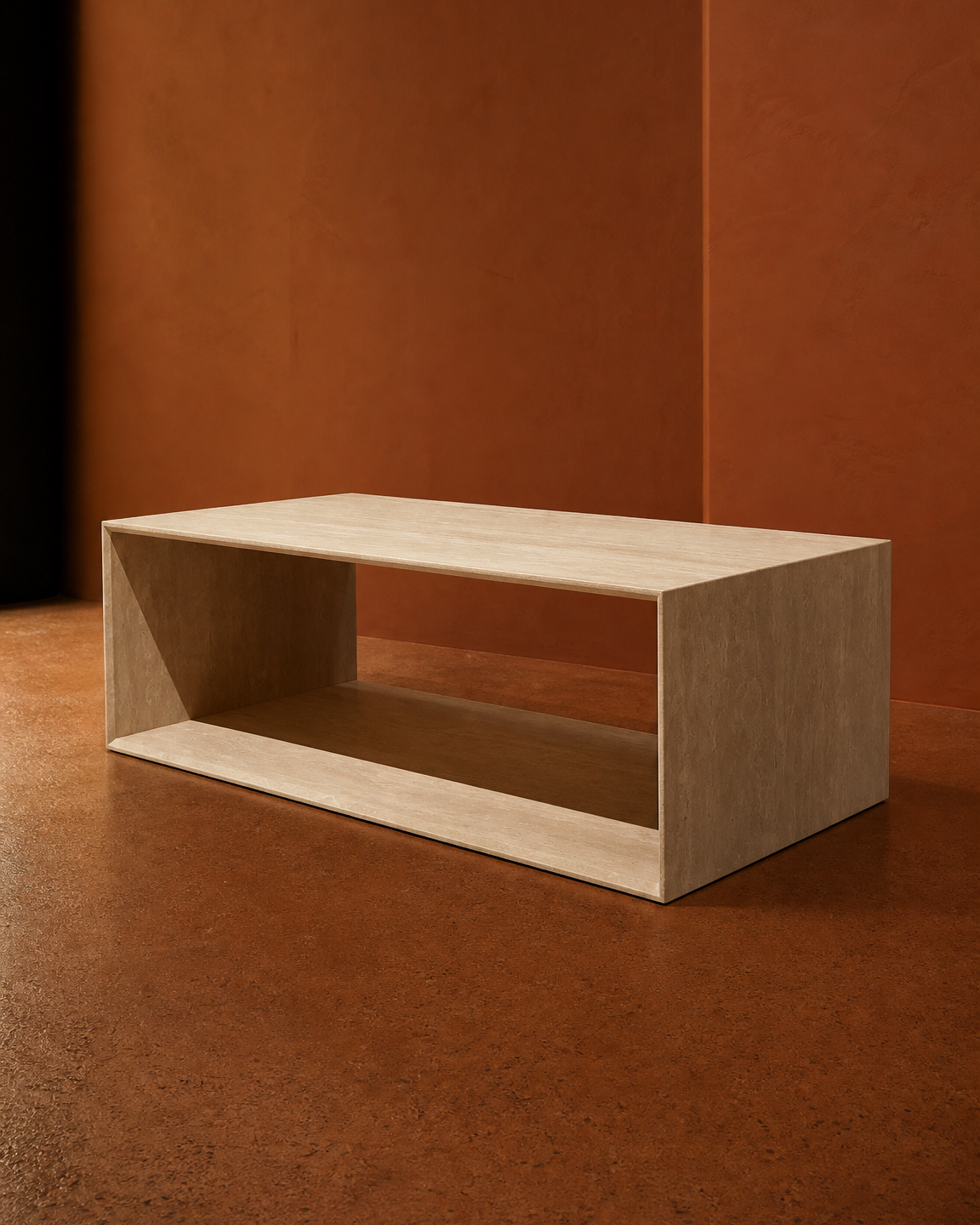 A minimalist rectangular travertine coffee table with an open lower shelf, shown in a warm, modern room setting with a textured terracotta wall and floor.