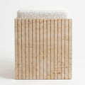 A modern square bench or stool with a textured off-white bouclé top and a slatted natural stone front in a warm beige tone, photographed against a clean white background.